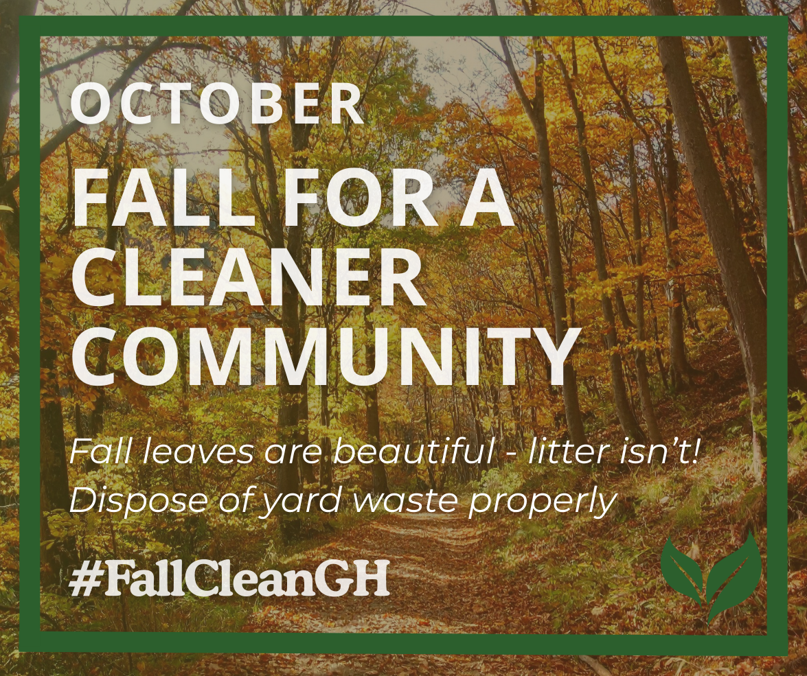 Autumn forest scene with a leaf-covered path surrounded by trees with orange, yellow and green foliage. A dark green border frames the image, with a green leaf graphic in the lower-right corner. Large white text reads: “OCTOBER – FALL FOR A CLEANER COMMUN